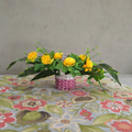 Vibrant Yellow Artificial Marigold Floral Arrangement in Pink Woven Basket